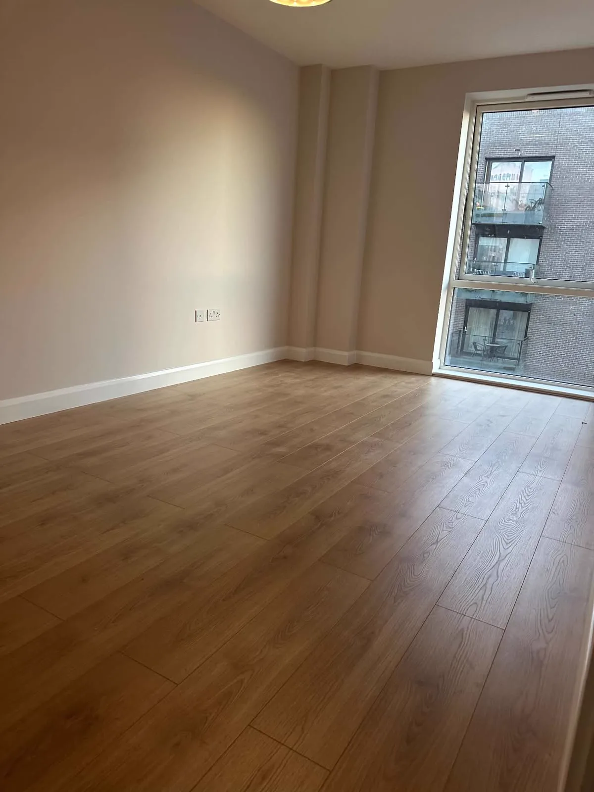 New oak-effect floor laid through a renovated room